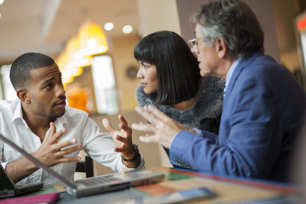 A team of sales agents discussing how the ARC method helps in overcoming sales objections