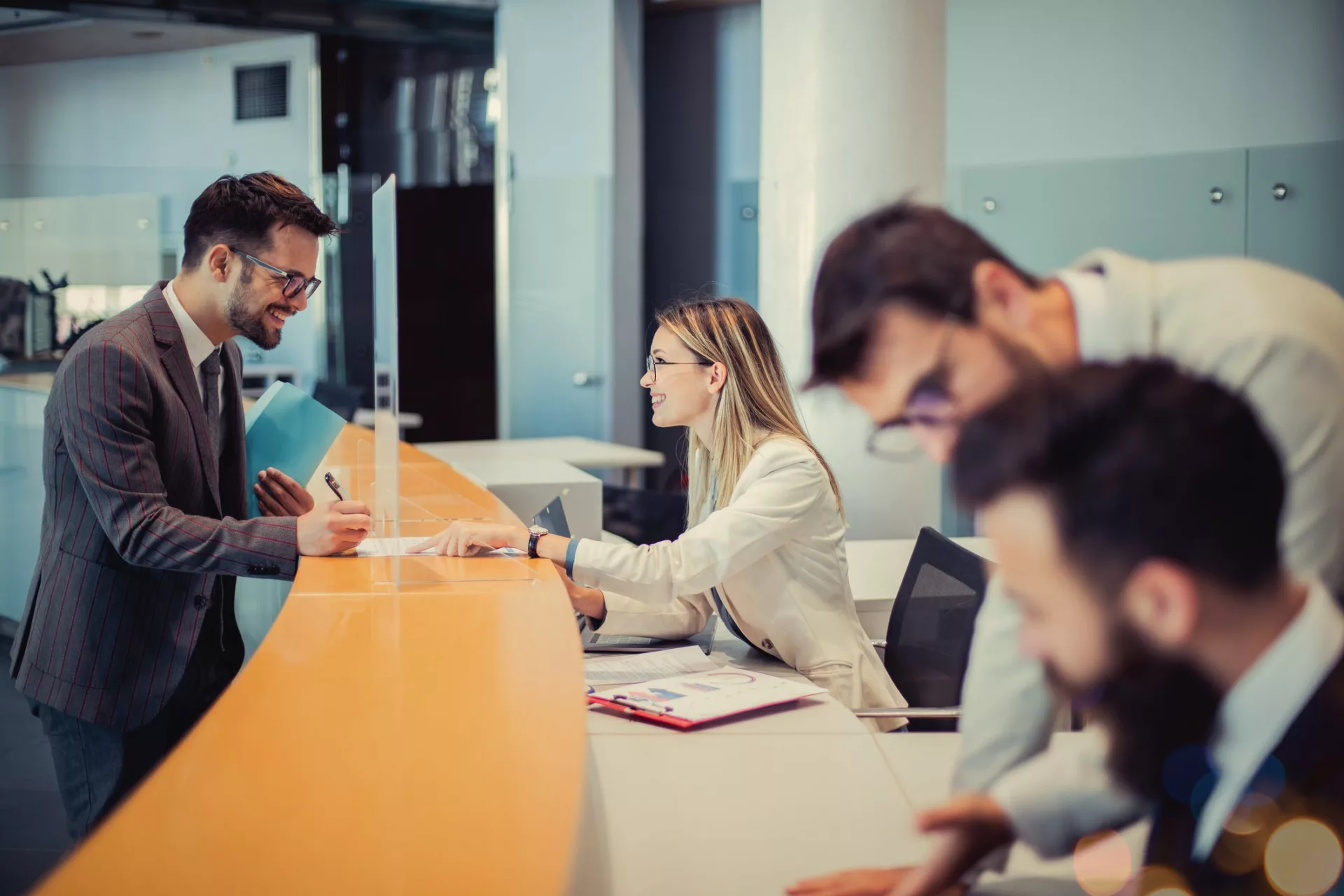 bank employee with customer demonstrating importance of knowledge management in finance