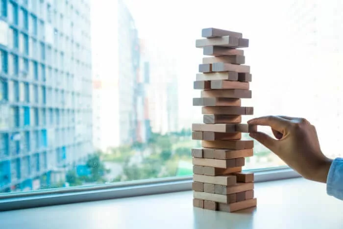 wobbly Jenga tower representing traditional knowledge management problems