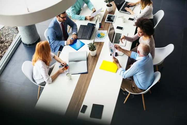 overhead view of business team reviewing knowledge tech stack