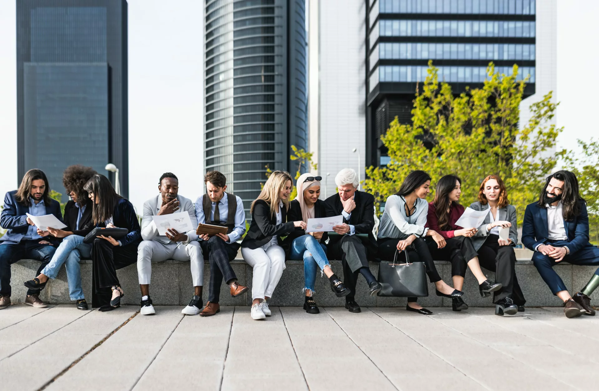 group of colleagues meet outside as part of company-wide knowledge management program