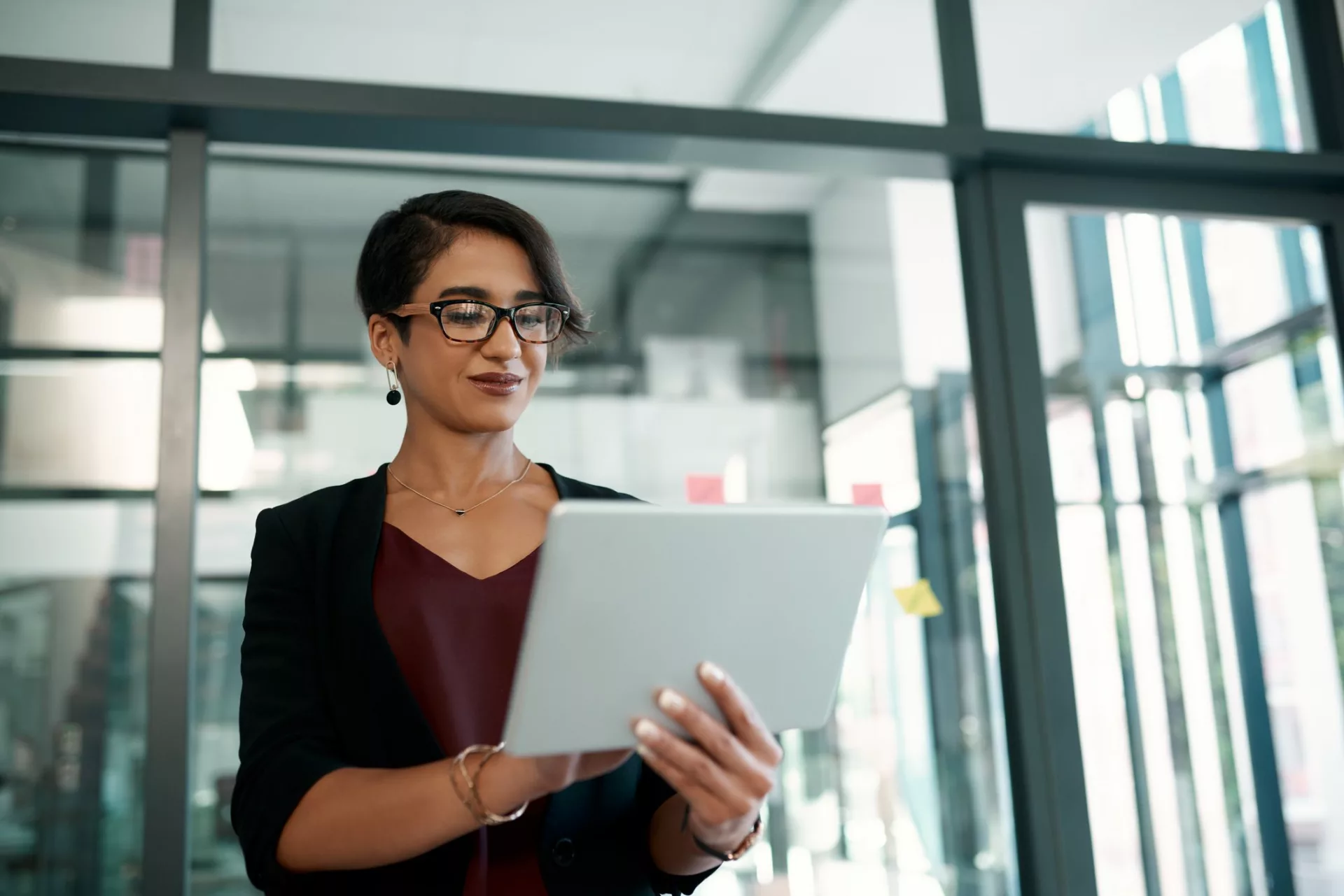 Businesswoman accesses company insights on tablet