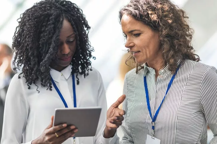 businesswoman at conference providing personalized customer service to client