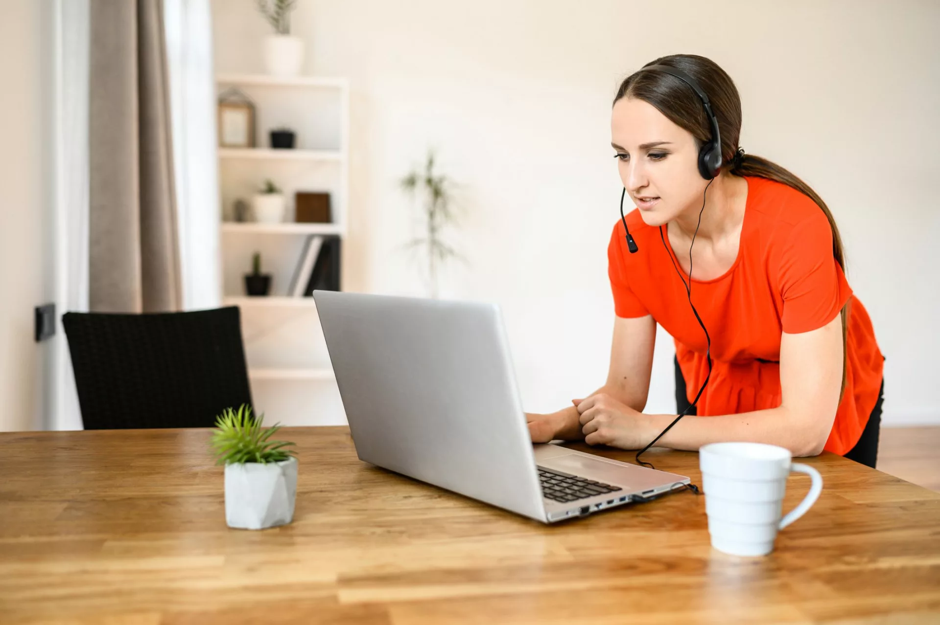 customer service agent stands at table while working remotely