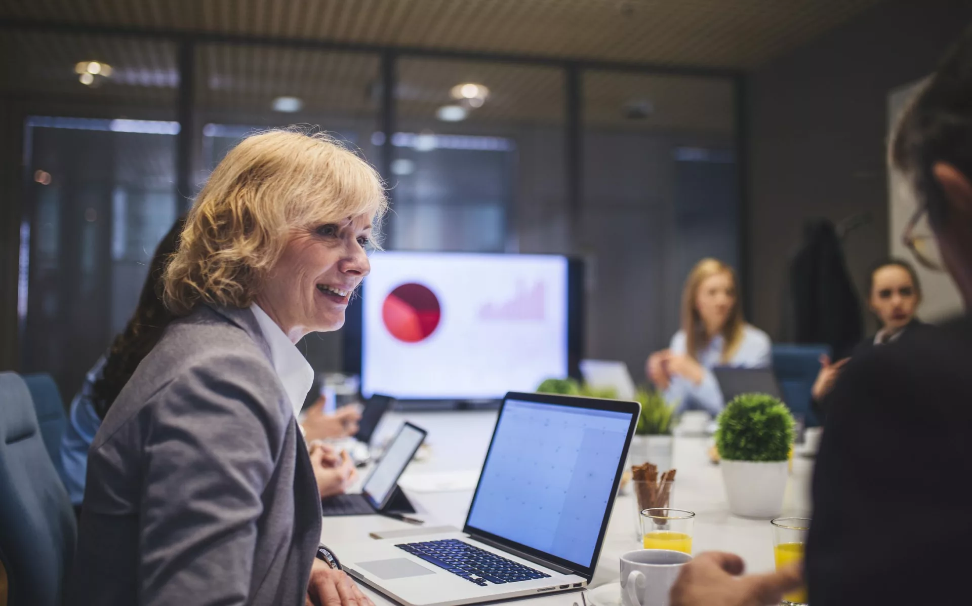 Coworkers meeting in conference room to discuss data and innovation