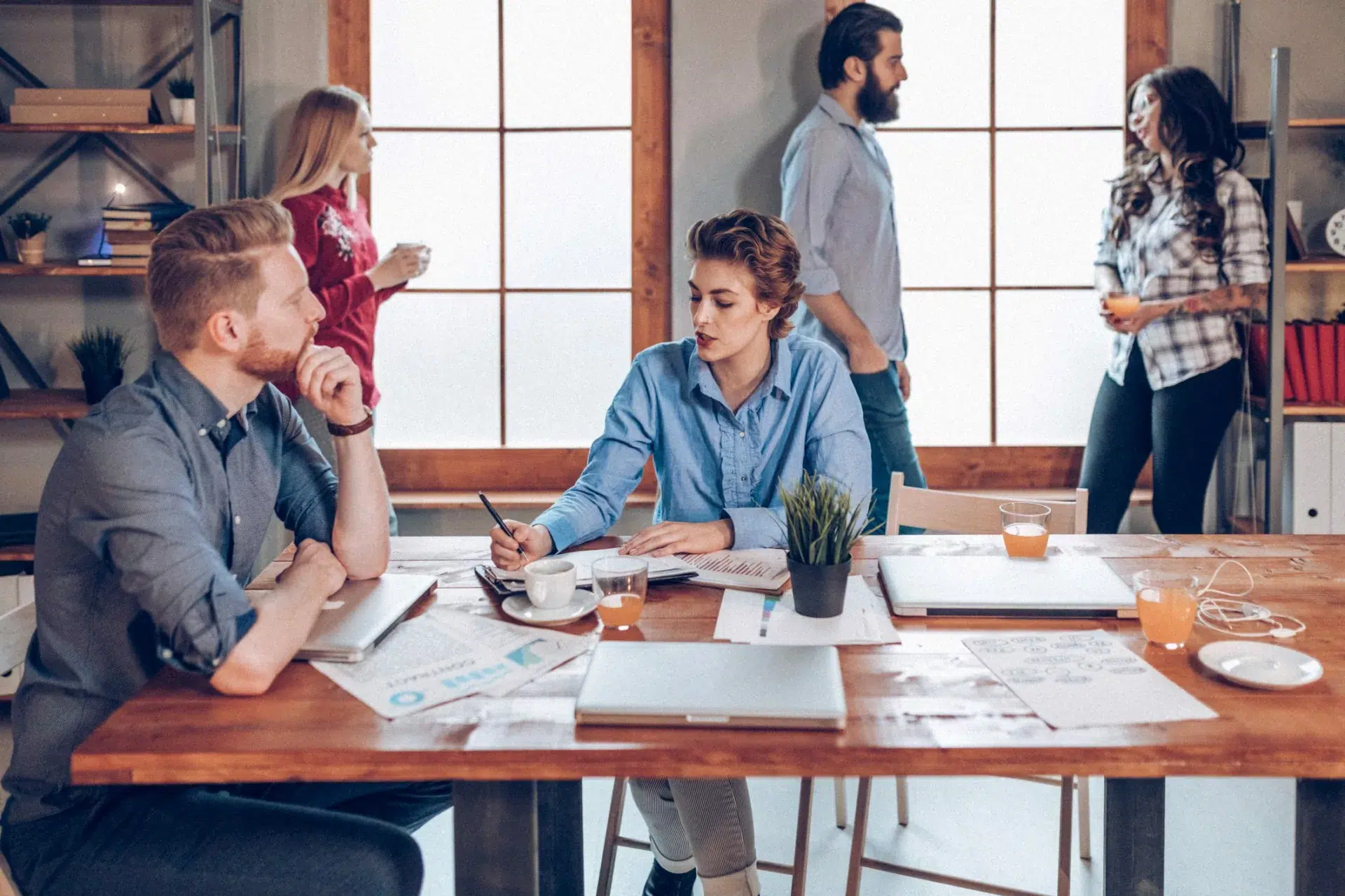 coworkers collaborating in open office