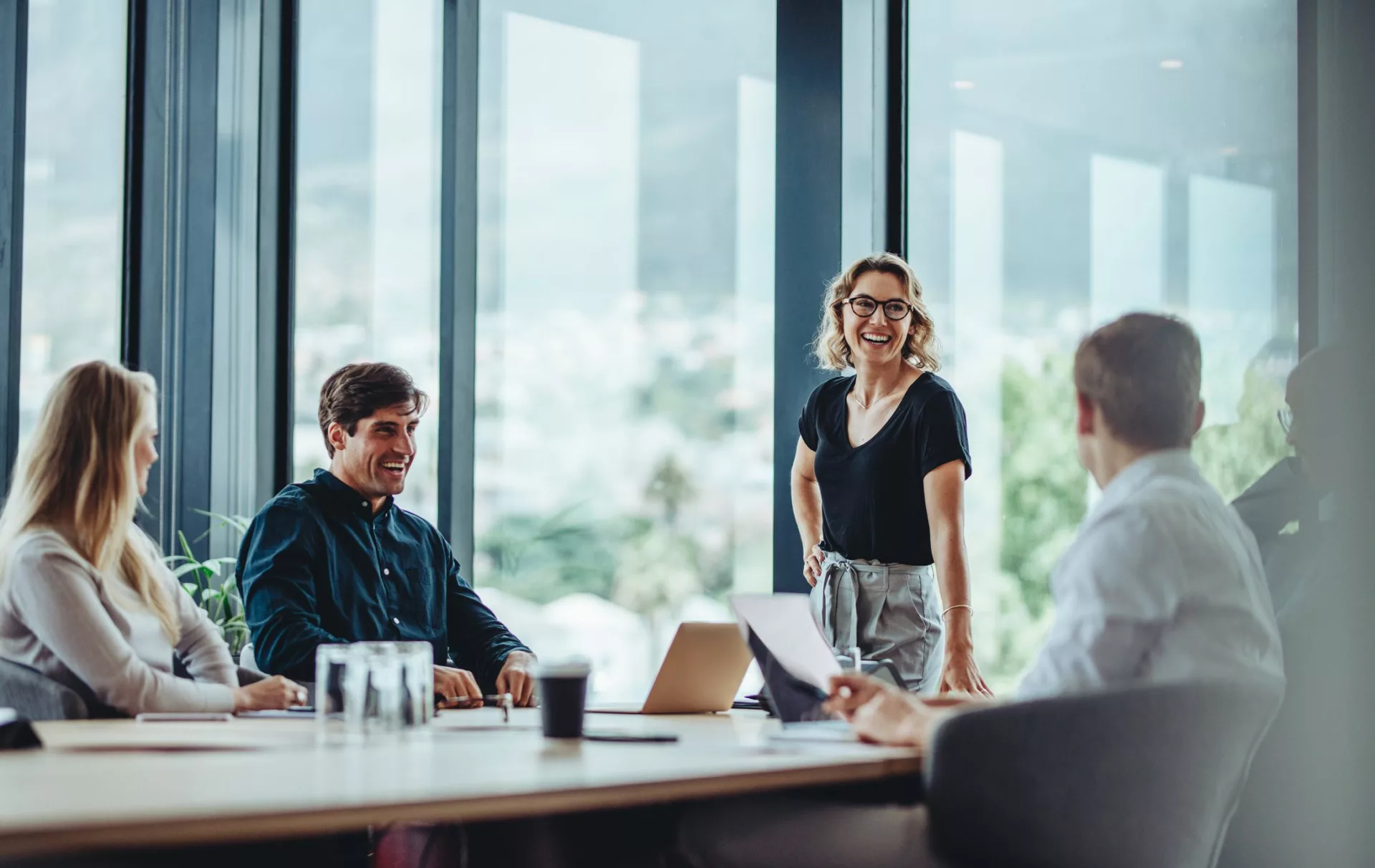 group of coworkers meet in conference room to discuss who is responsible for knowledge management