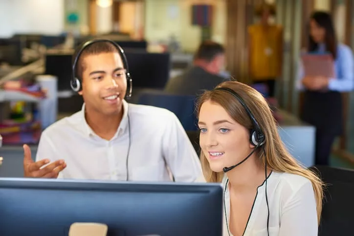 customer support reps with headsets demonstrate knowledge-centered support methodology