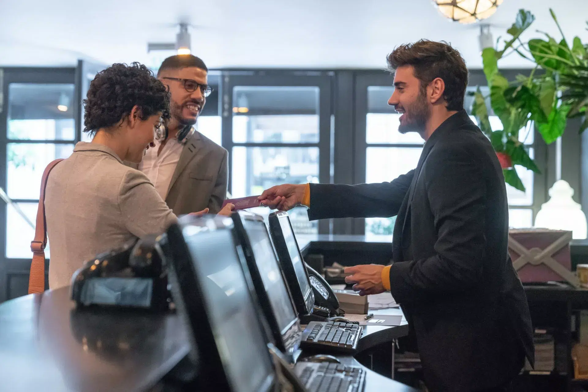 hotel front desk employee demonstrating knowledge management in hospitality industry