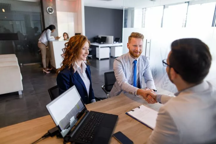 loan officer with couple representing financial services change management