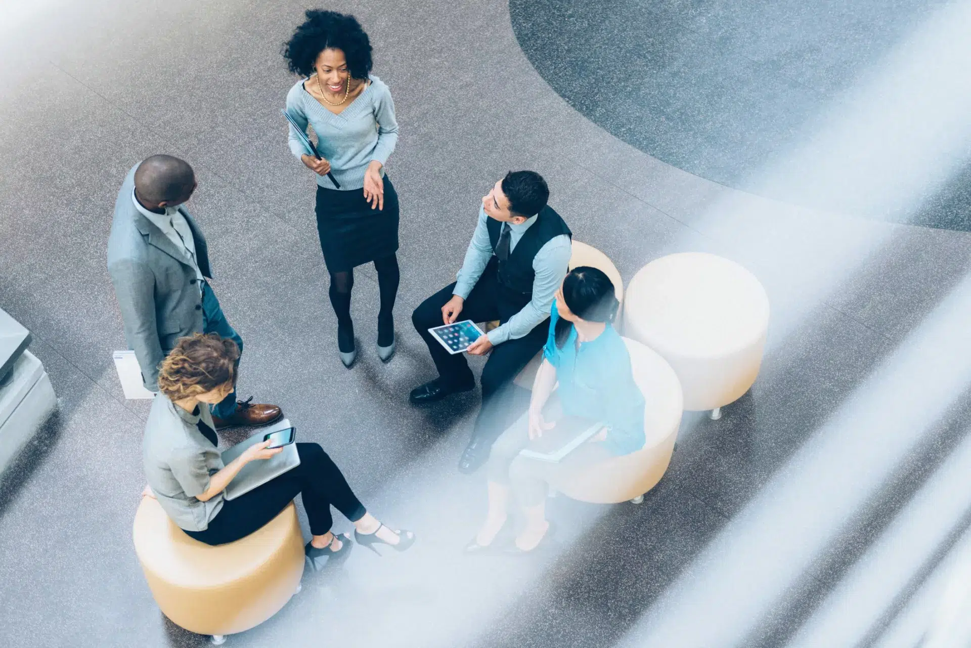 businesspeople meeting in atrium demonstrate how knowledge management enhances decision-making