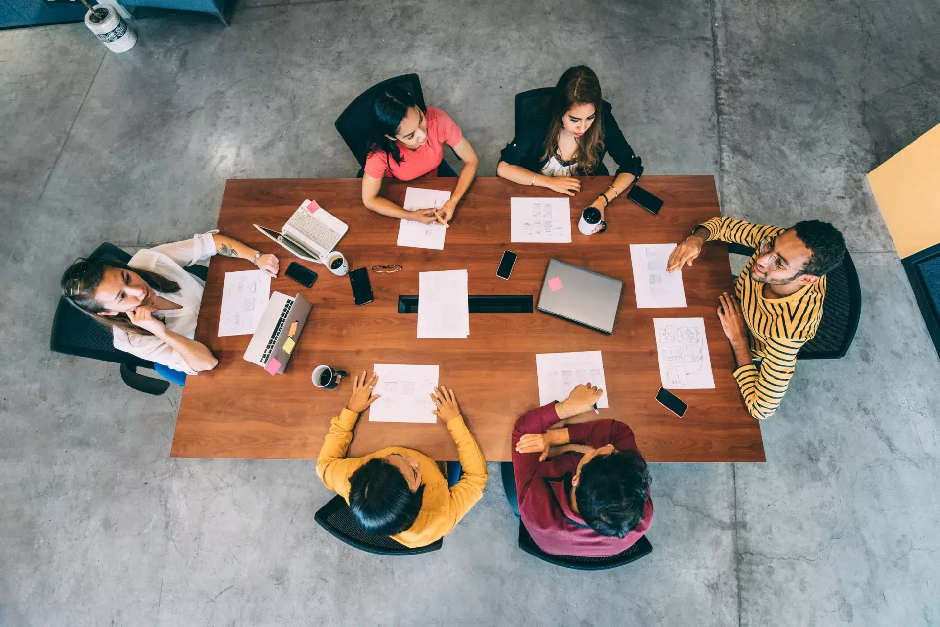 overhead view of colleagues in open office sharing knowledge engagement strategy tips