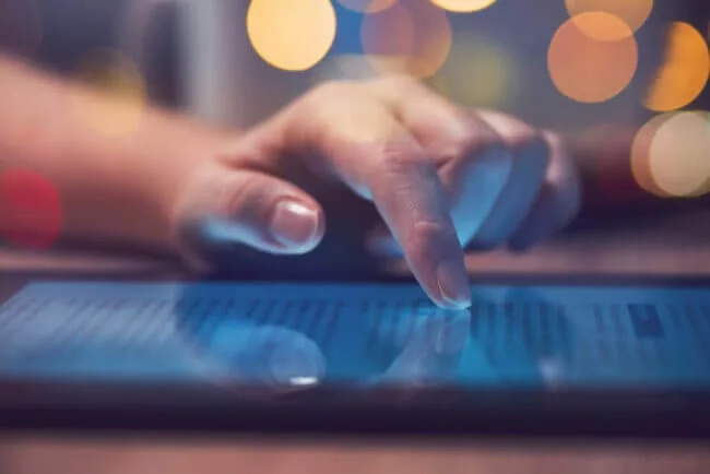 woman enjoys personalized experience scrolling through recommended content on tablet