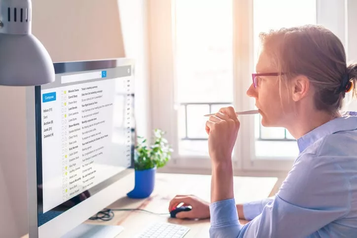 businesswoman practicing email inbox management on desktop
