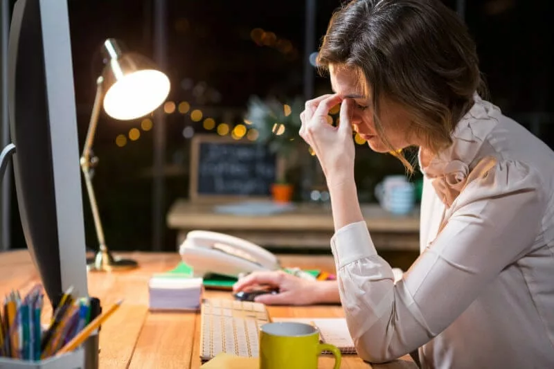 stressed businesswoman working late showing challenges in sales