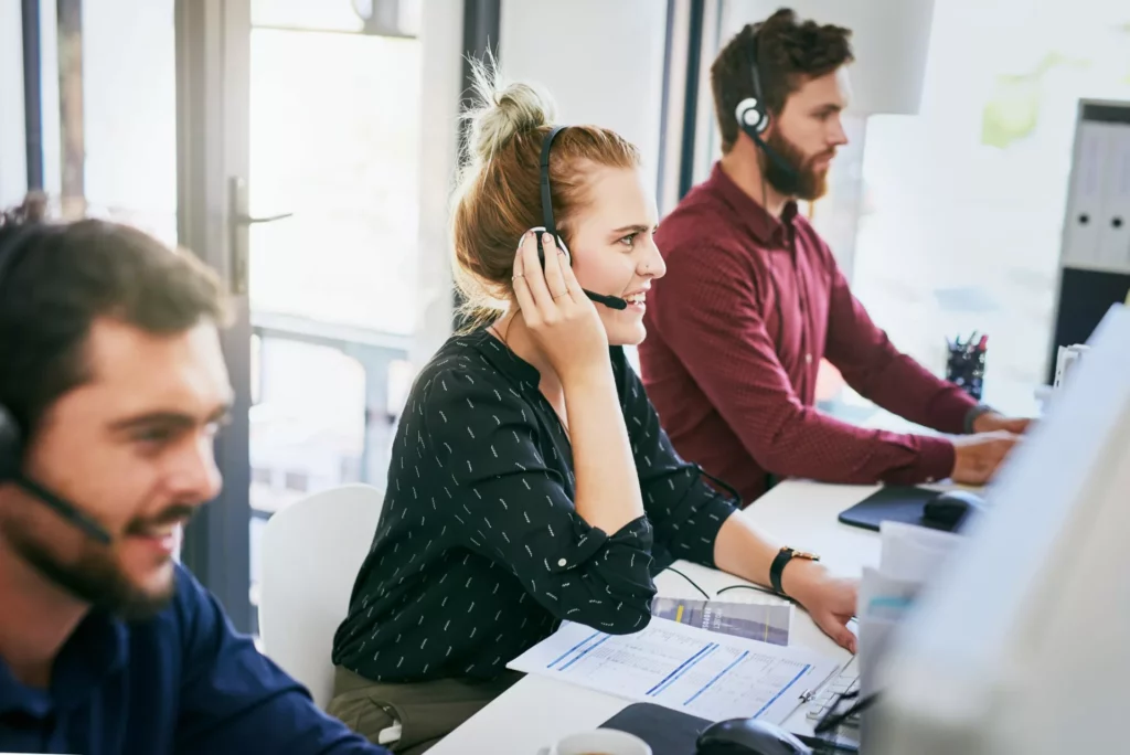 three customer service reps on phone calls demonstrate the value of knowledge management for customer service|The_Value_of_Bloomfire_for_Customer_Support_Teams