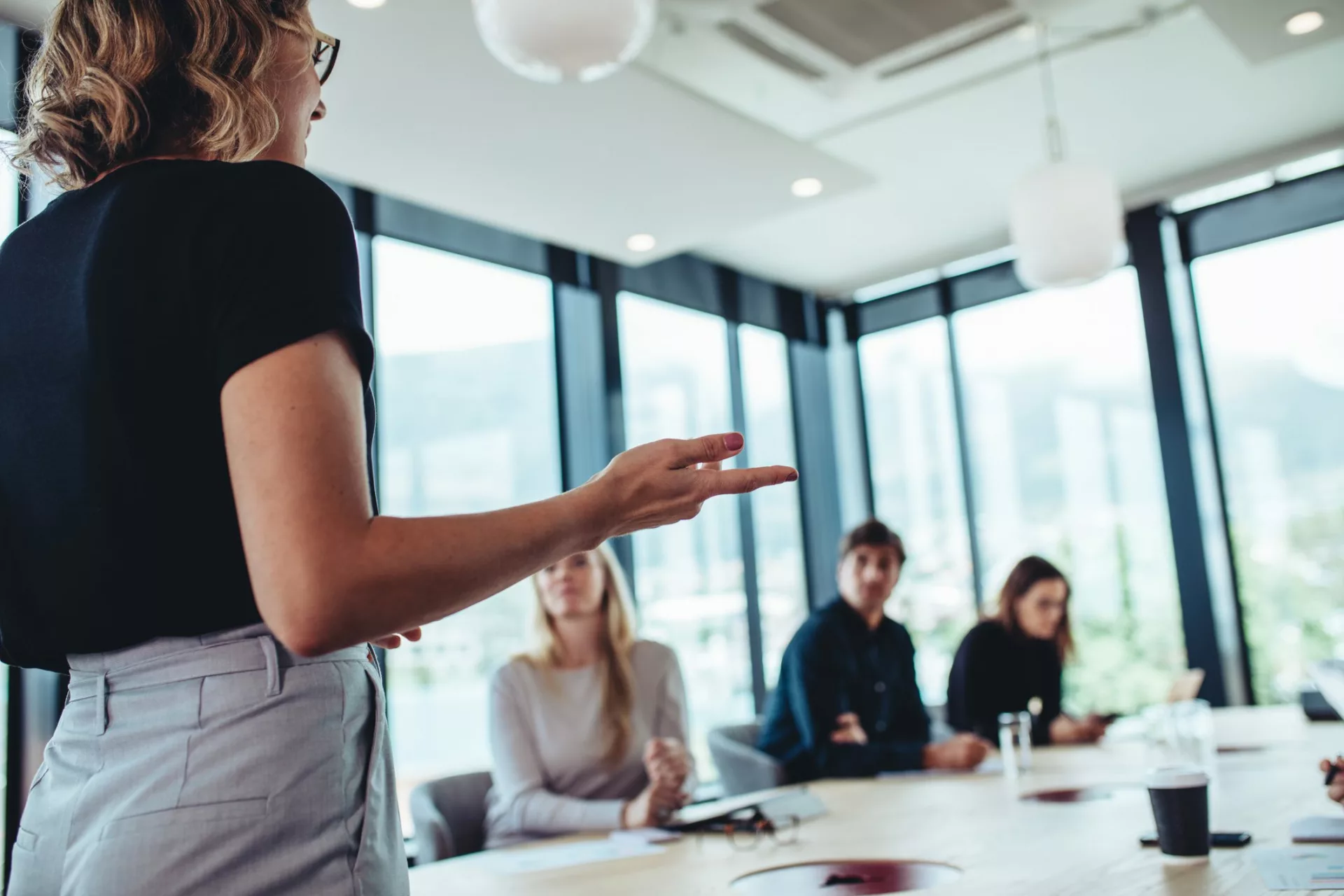 woman presenting business case to secure budget for knowledge management initiative