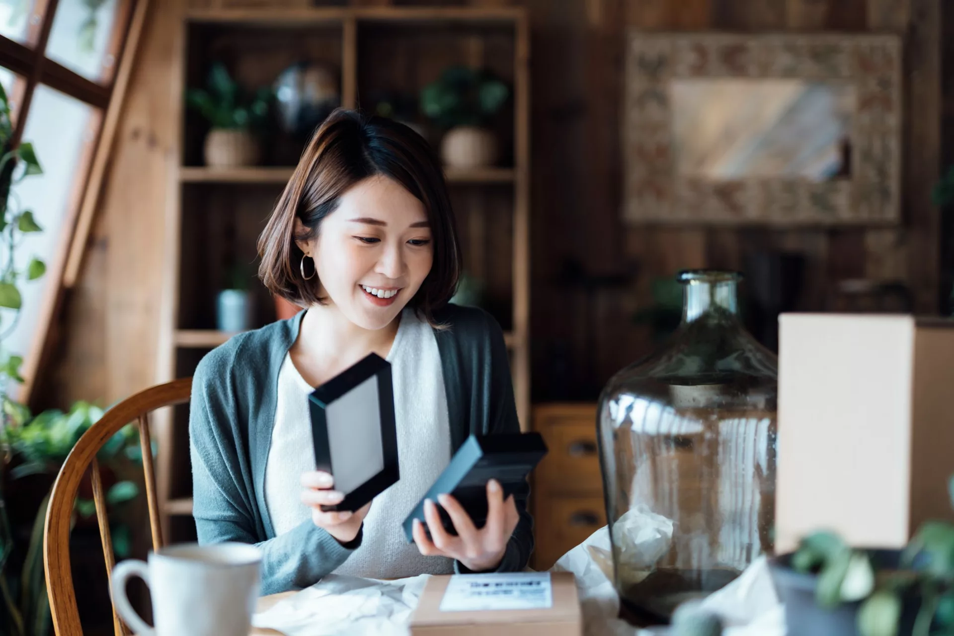 Woman opening a box at home