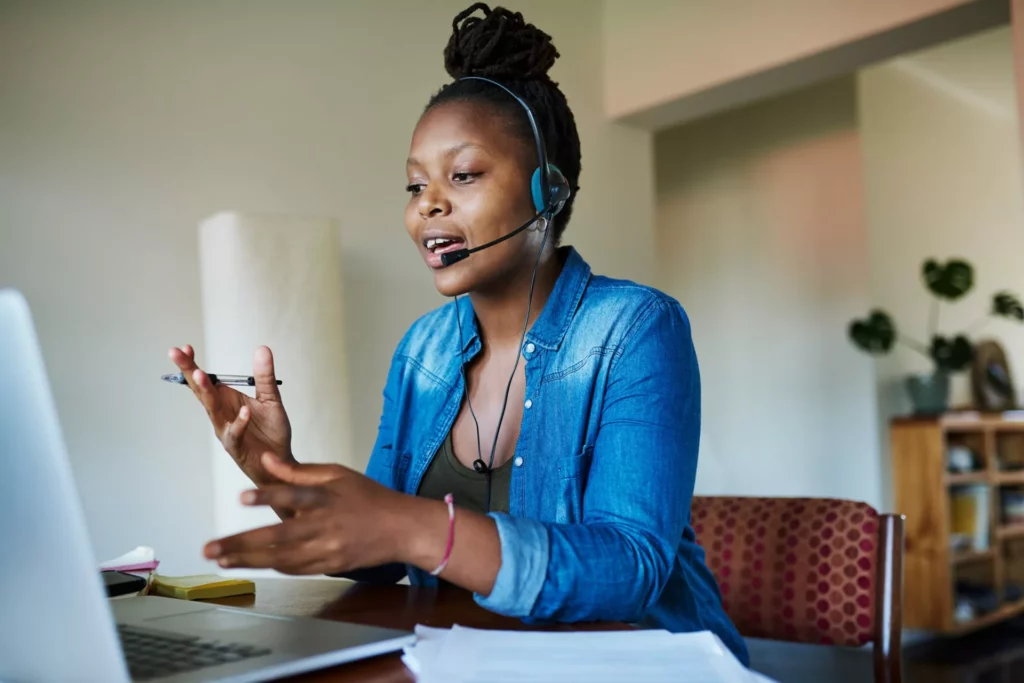 woman wearing headset and working from home demonstrates how to scale customer support