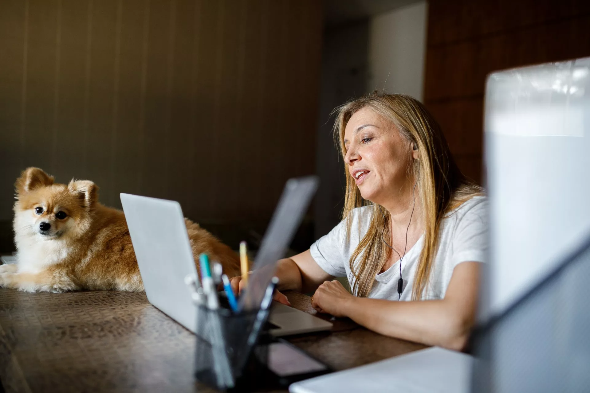 woman working remotely with dog and taking video call