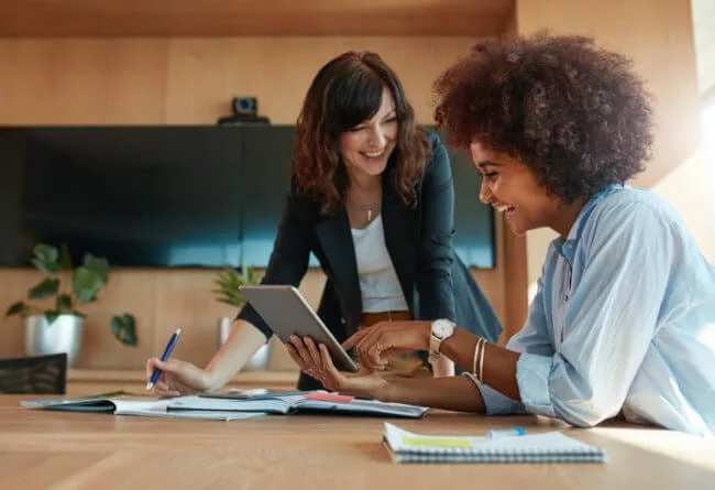 women executives looking at tablet planning strategies to increase employee engagement