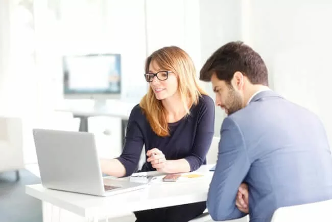 salespeople working on request for proposal at laptop demonstrating RFP best practices