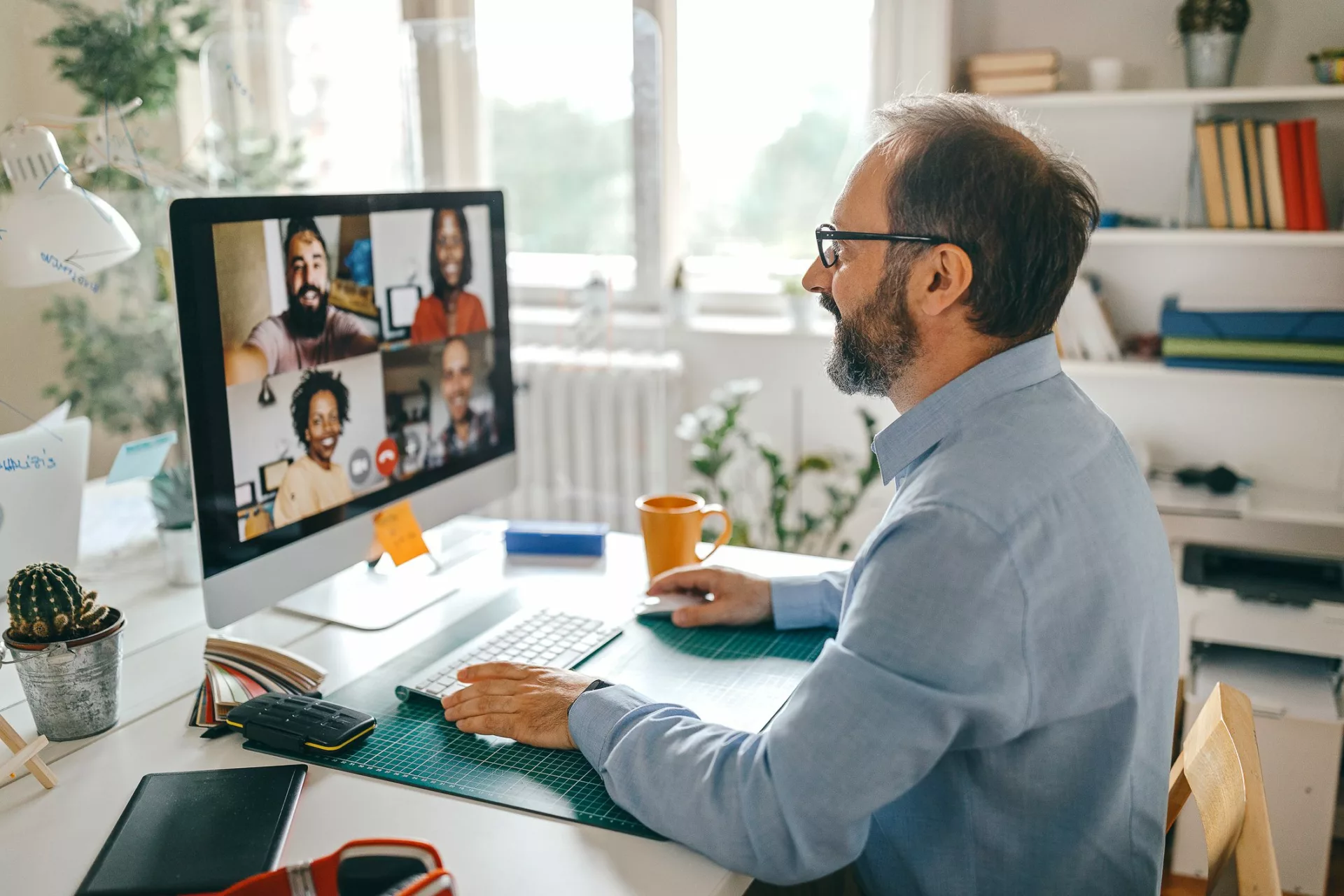 senior leader working to improve workplace communication with virtual team meeting