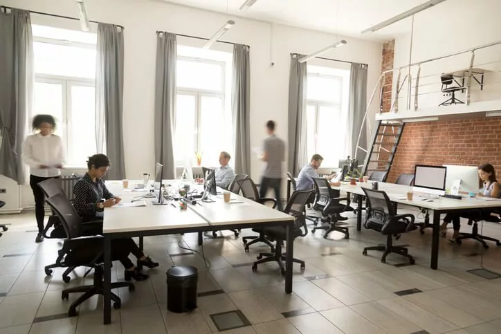 open office democratized knowledge concept|coworkers laughing during meeting
