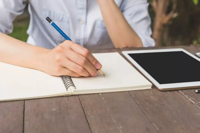 student works on microlearning lesson with notebook and tablet