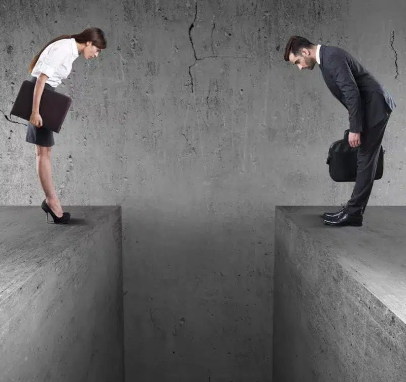 Two business people separated by a large gap in the floor representing silos.