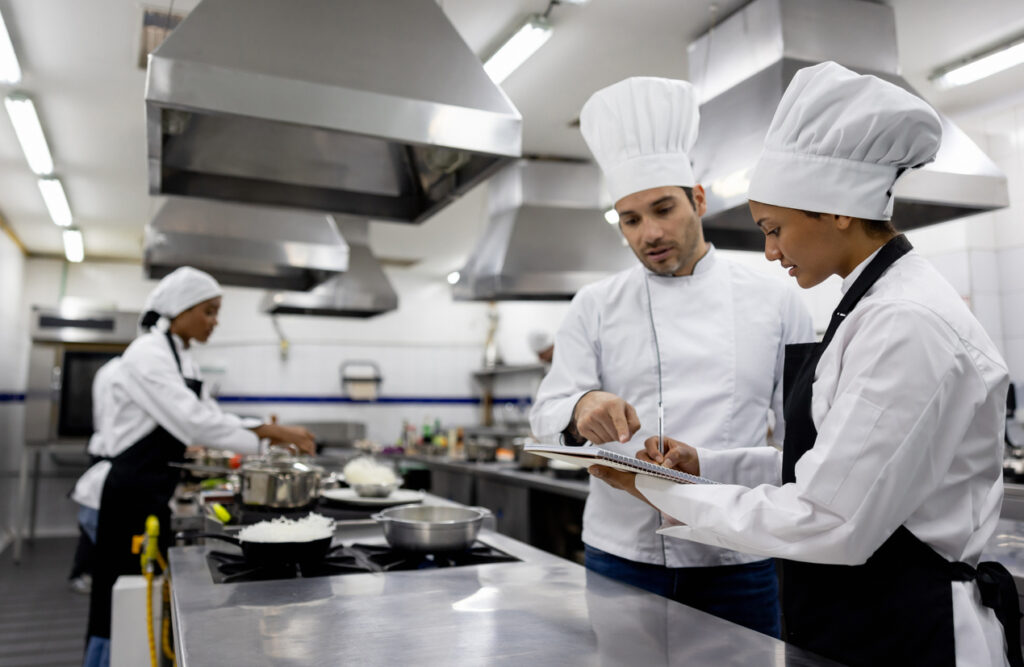 Chef talking to a student in a cooking class