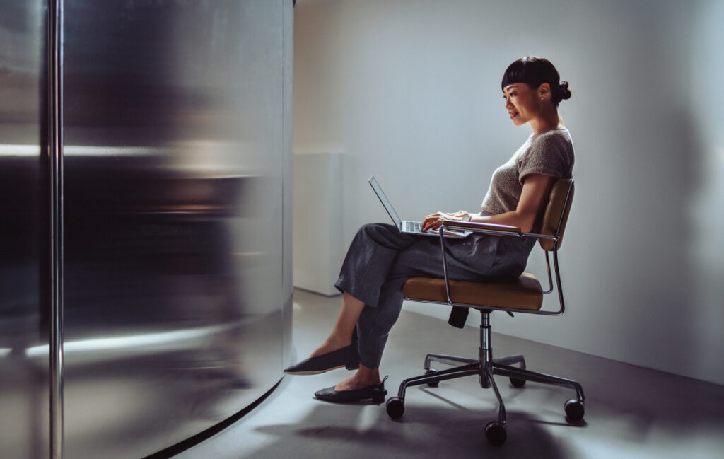 Professional woman working on a laptop, representing productivity gains from Enterprise Intelligence.