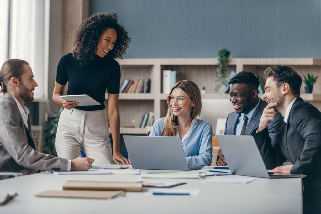 A group of employees happily making decisions with the help of a customer insights platform