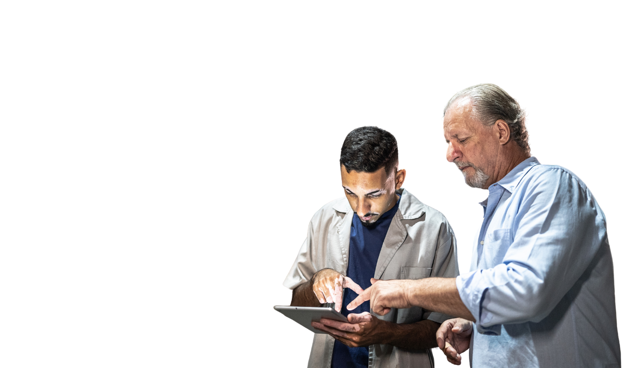Two product management employees looking at something on a tablet