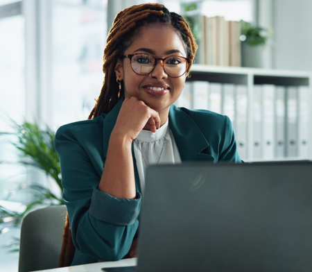 Smiling legal and compliance employee at her laptop