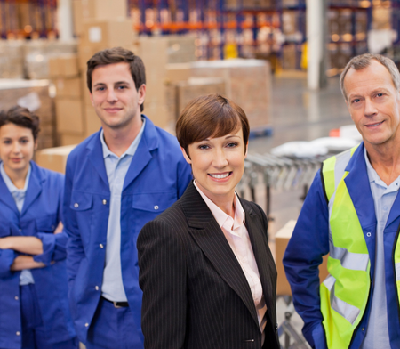Procurement team smiling in warehouse