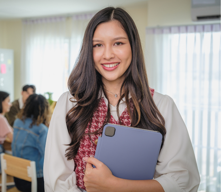 R&D employee smiling and holding a tablet