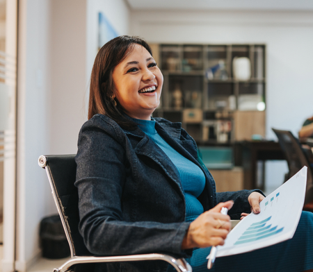 Sales manager leaning back in chair and smiling