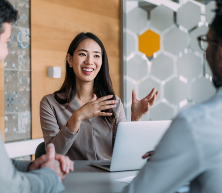 Account manager in meeting smiling and talking with hands