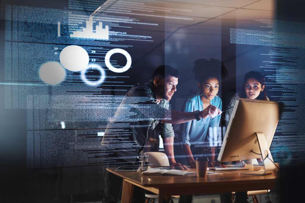 Three colleagues gathered around a desktop computer analyzing data, with an overlay of code, charts, and metrics visualizing the hidden dark data buried within enterprise systems.